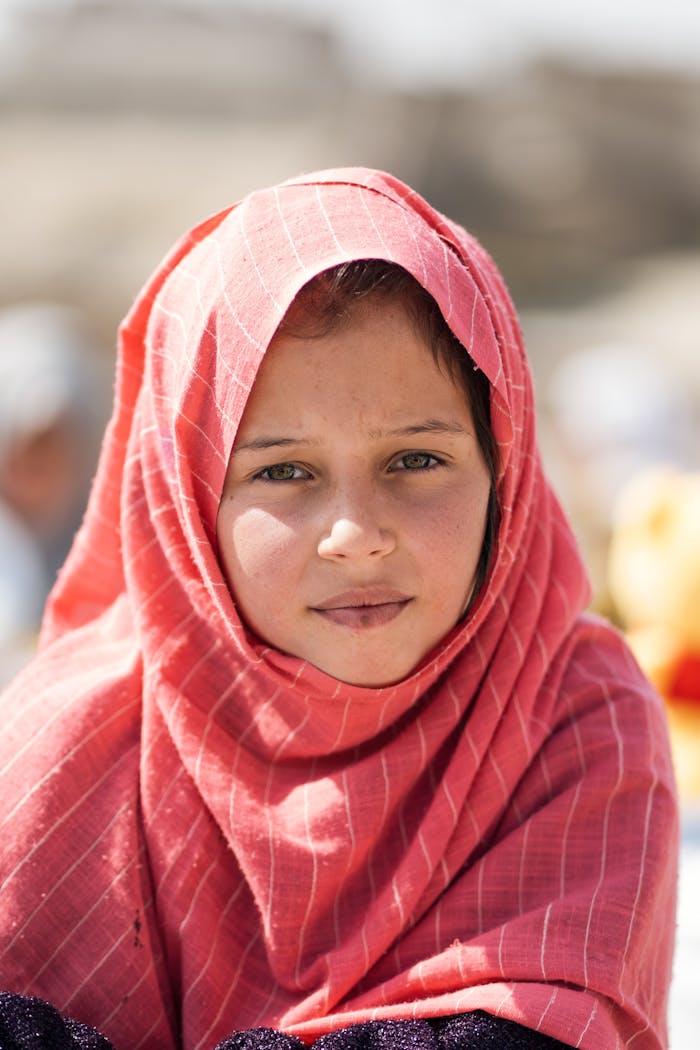 about-01 Captivating portrait of an Afghan girl wearing a red hijab, showcasing cultural diversity and resilience.